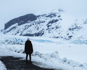 Woman standing in front of Skaftafellsjökull, Skaftafell National Park, Iceland