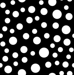Seamless random size white polka dots pattern with on black background © Ahmet