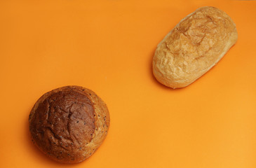 bread with flax and ciabata on an orange background