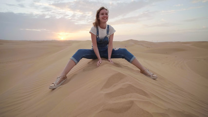 Fototapeta na wymiar Happy girl in the desert of the arab emirates.