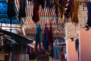 Fototapeta na wymiar Multicolor of raw silk threads are hanging after dyed color in the historic Souk of Marrakech