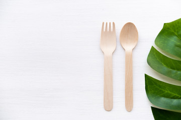 eco friendly disposable kitchenware utensils on white background. wooden forks and spoons. ecology, zero waste concept. top view. flat lay. copyspace.