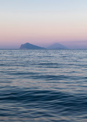 Volcano Stromboli and island Panarea with ocean and waves during sunset, Sicily Italy.