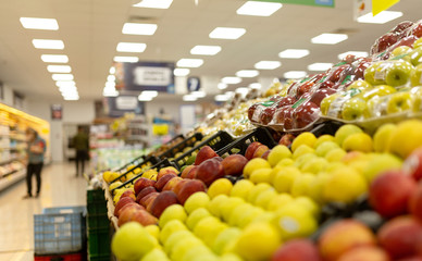Supermarket interior, filled with the fruit of the shopping cart.