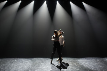 Beautiful couple of professional artists dancing  salsa