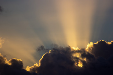 sunset rays behind the clouds