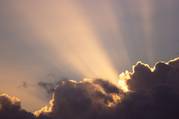 sunset rays behind the clouds