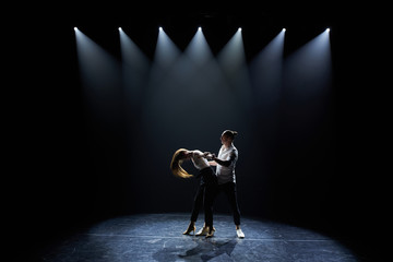 Beautiful couple of professional artists dancing  salsa