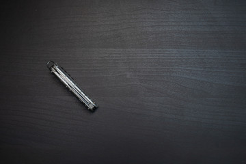 pocketknife on dark wooden table