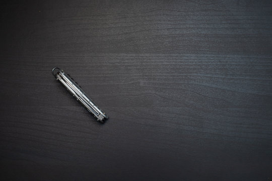 pocketknife on dark wooden table