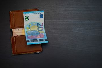 wallet with money on the dark wooden table