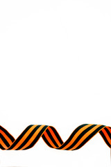 orange and black striped ribbon symbol on May 9 and 23 February. Victory day St George ribbon. Victory day greeting card concept, copy space