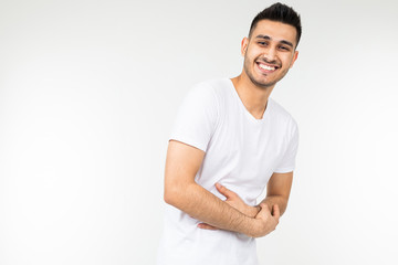 handsome man shows stomach pain on a white studio background