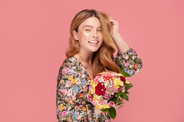 Smiling woman with flowers in hand