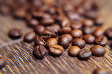 Bag of roasted coffee beans on a dark background with burlap fabric, close view. Coffee beans...