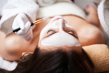 Pretty woman relaxes during spa treatments at beauty salon