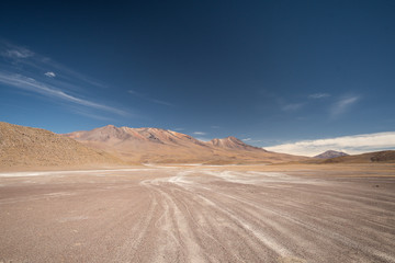 Fototapeta na wymiar High Andean altiplano desert in Bolivia with jeep tracks on Ruta de Las Lagunas