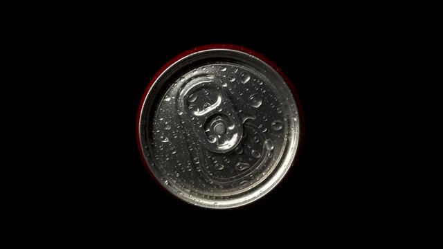 Red can rotate on black background. Top down view of metal can unopened. bottle in small drops of water.