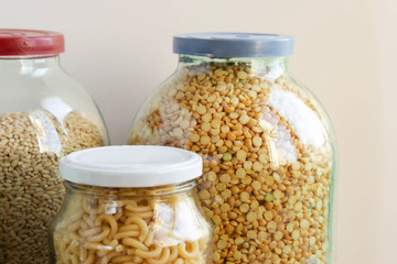 various cereals in glass jars isolated on a white background. Close up