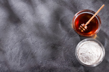 Baking soda and pure honey in glass bowls - Text space