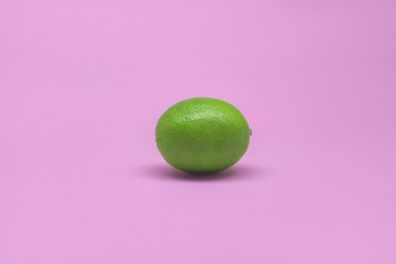 Fresh lime isolated on a lilac background. Summer and seasonal fruits for a healthy lifestyle. Health care.