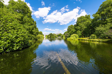 London wide angle cityscape view buildings from St James Park green lake pond on summer day and...