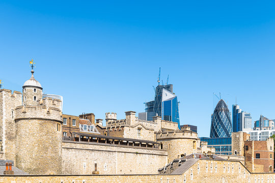 London, UK cityscape view of downtown city and foreground of tower bridge stone fortress and blue sky in summer