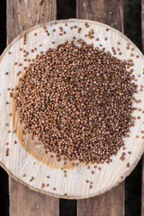 
buckwheat porridge buckwheat AND SPOON background wood wooden background dark background Buckwheat and sheet paper for notes and notes