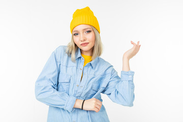 cool stylish girl in a blue shirt and yellow sweater posing on a white background