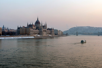 Fototapeta na wymiar The river Danube on a cold winter day with the Hungarian Parliament building in the background