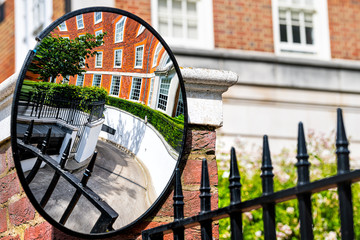 London, UK neighborhood district of Kensington with mirror closeup reflection of driveway on alley street mews with empty road architecture and nobody
