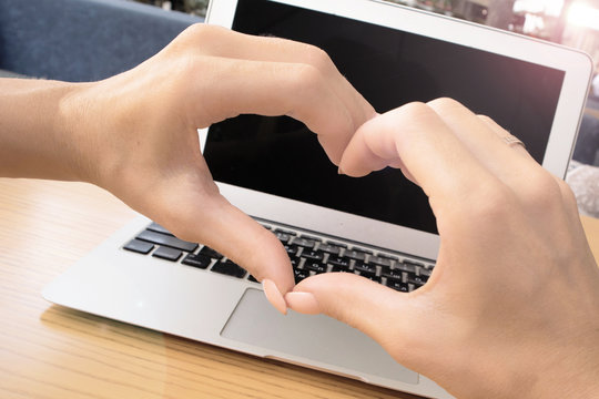 Close Up Of Heart From Hands Of A  Young Girl On A Laptop In A Cafe Outside,love Technology