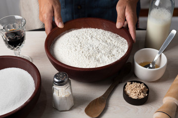 hands kneading flour, yeast eggs bakery ingredients milk honey in home kitchen