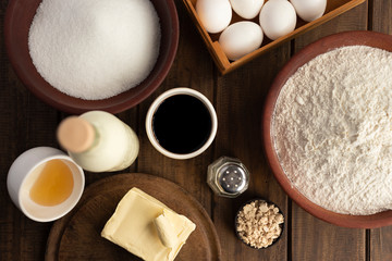 
wooden bowl with flour butter hollow honey sugar yeast, ingredients for pastry