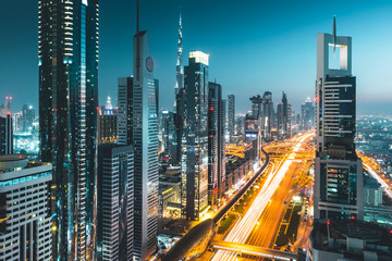 Fototapeta na wymiar Long exposure view of traffic and skyline from rooftop at night Dubai - UAE