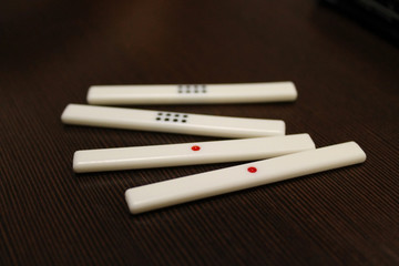 Counting sticks for mahjong are on the table, the back and side plans are blurred. Table traditional game of China, Japan, and other Asian countries.