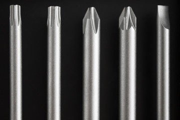 A set of long bits for a screwdriver. Different form, five kinds. Dark background.