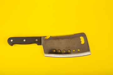 Butcher knife with wooden handle on yellow background