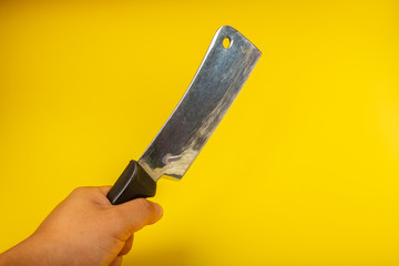 Butcher knife with wooden handle on yellow background