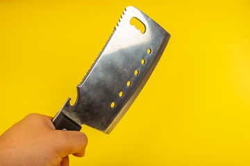 Butcher knife with wooden handle on yellow background