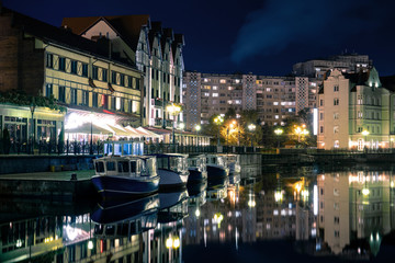 boats at a deserted pier in the night city