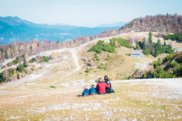 A group of people sitting on top of a mountain