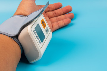 Measuring the Blood Pressure with Chinese word instruction isolated on blue background 