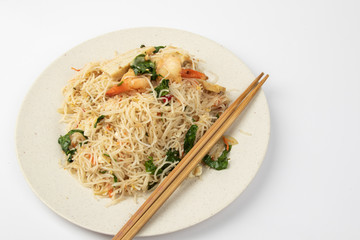 Homemade fish sauce fried bee hoon with few fresh prawn and vegetable on white background.
