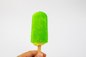 Man hand holding Ice Cream Popsicle Lime taste on White Background.