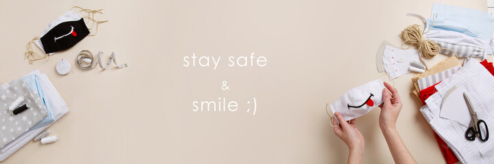 Handmade funny kinder face masks with smile. Smile & stay safe. Antiviral prevent measures. Zero waste optimistic mood. DIY face mask  at pandemic or quarantine. Sewing Cotton natural face-mask banner