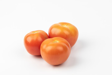 Fresh raw tomato isolated on white background.