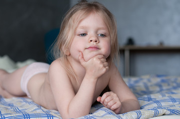 Portrait of a little girl with white hair and blue eyes