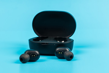 Wireless bluetooth headphones isolated on blue background