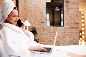 Pretty woman after shower chatting on a laptop